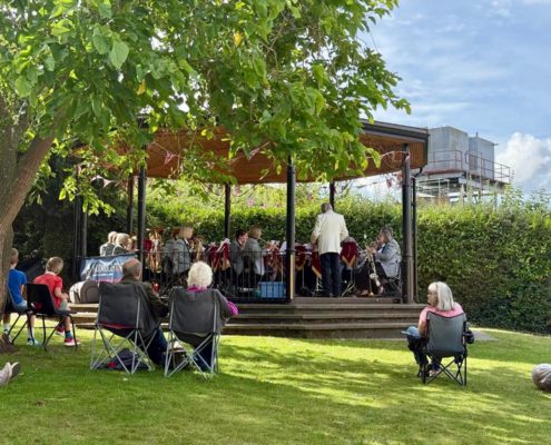 Harlow Concert Band playing in front of a small audience of people