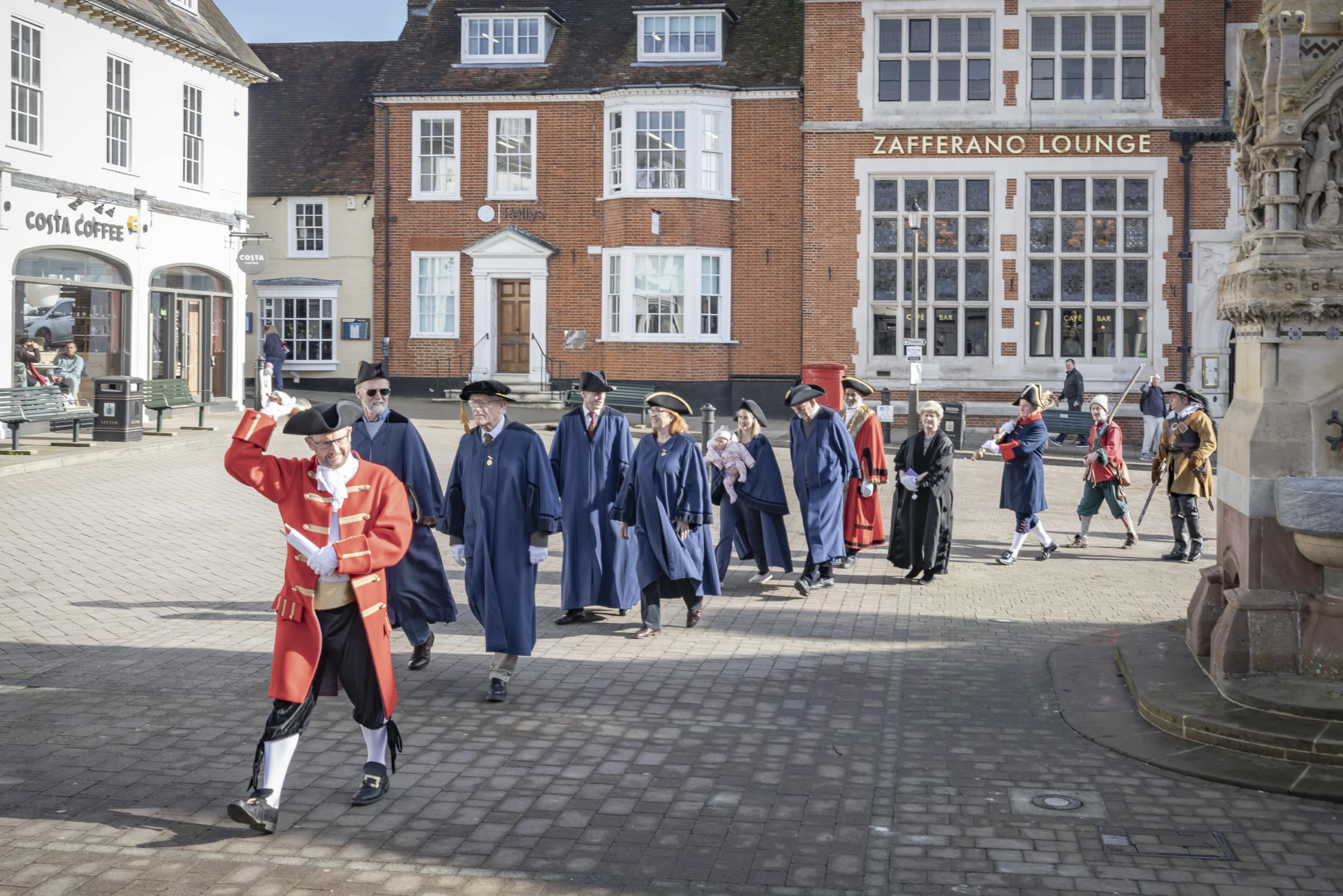 Saffron Walden Town Councillors are led into the Market Place by the Town Crier. Photo credit: Celia Bartlett